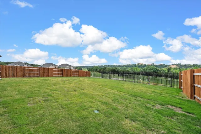 a view of a field with a big yard