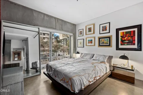 a bedroom with a large bed and a window