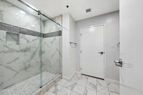 a bathroom with a shower and a sink