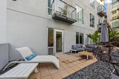 a view of a patio with couple of chairs and couch