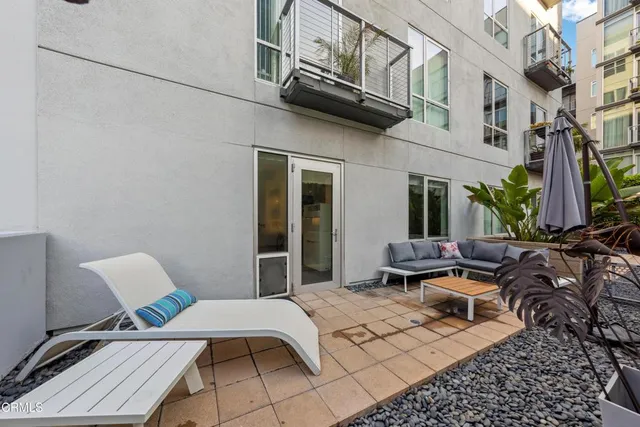 a view of a patio with couple of chairs and couch