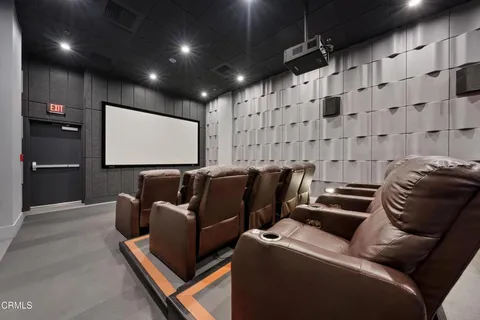 a media room with lots of chairs and a projector screen