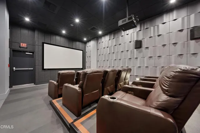 a media room with lots of chairs and a projector screen