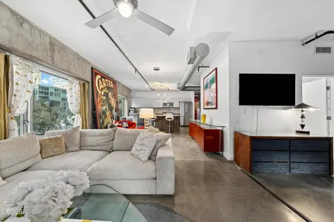 a living room with furniture and a flat screen tv