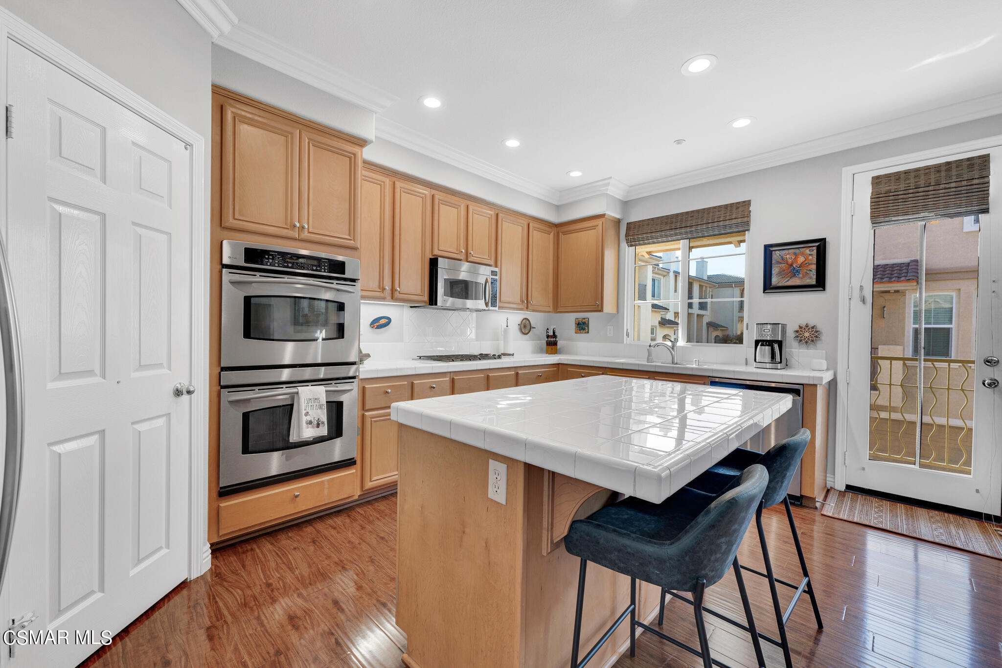 1233 Bayside Circle Oxnard, CA 93035 - Photo 14 of 37 a kitchen with stainless steel appliances granite countertop a stove refrigerator sink and microwave