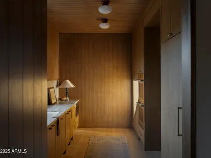 a front view of a house with a garden and lake view