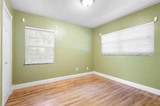 a view of a room with wooden floor and windows