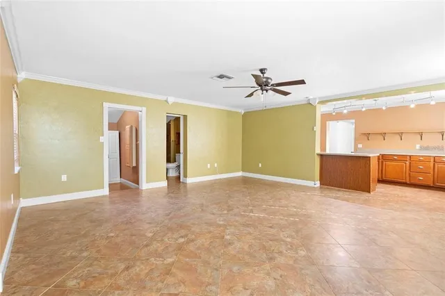 a view of a livingroom with a ceiling fan and window