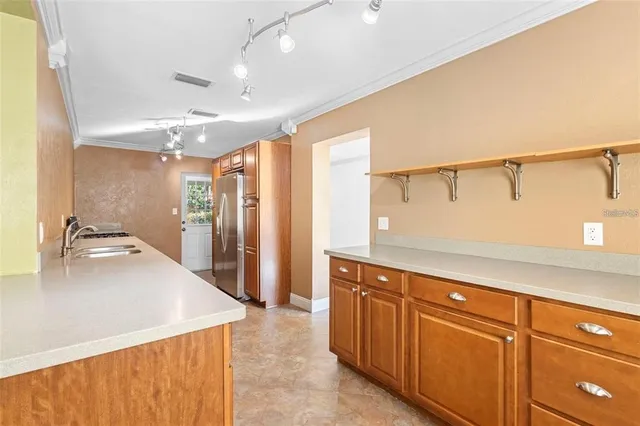 a kitchen with stainless steel appliances a refrigerator and a sink