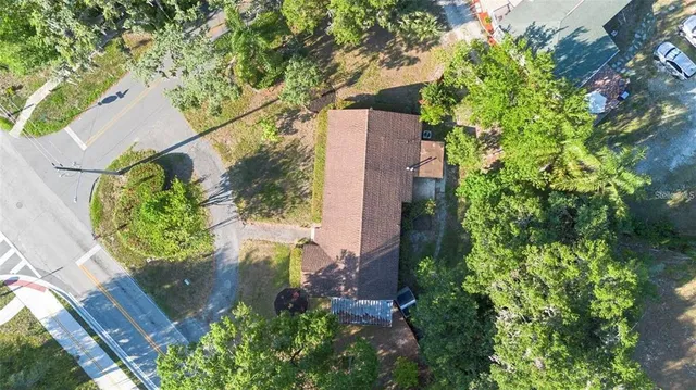 an aerial view of a house with a yard