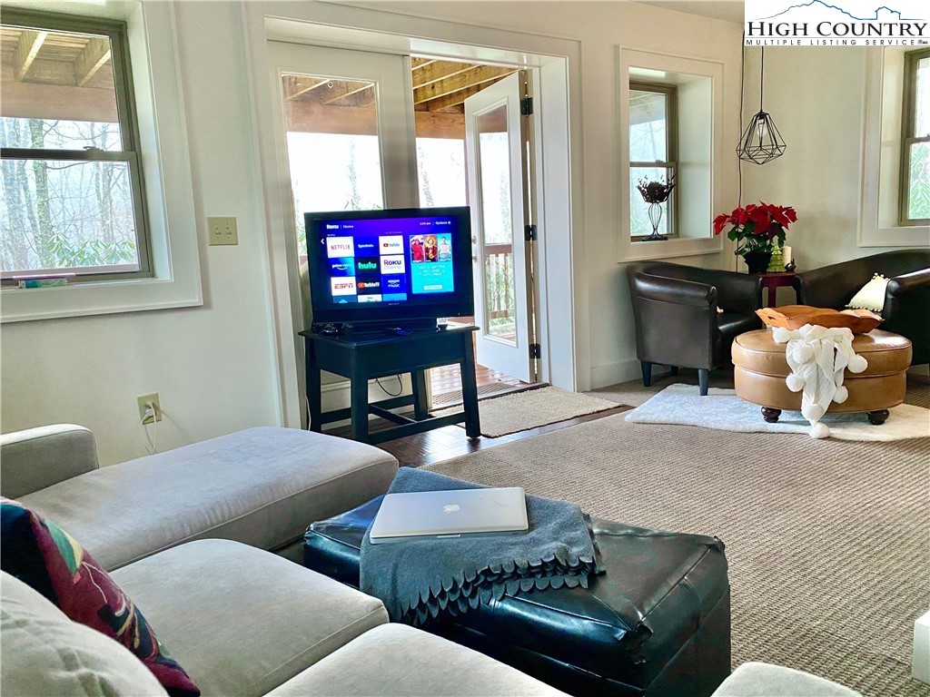 702 Pine Ridge Road Beech Mountain, NC 28604 - Photo 11 of 24 a living room with furniture and a flat screen tv
