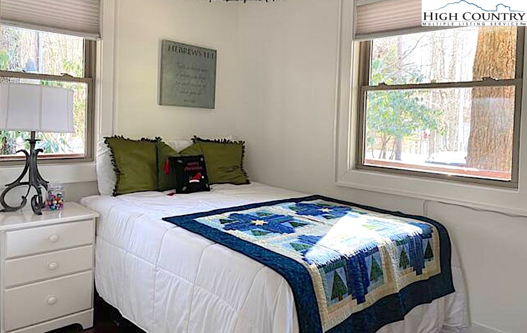 702 Pine Ridge Road Beech Mountain, NC 28604 - Photo 15 of 24 a bedroom with a bed and a window