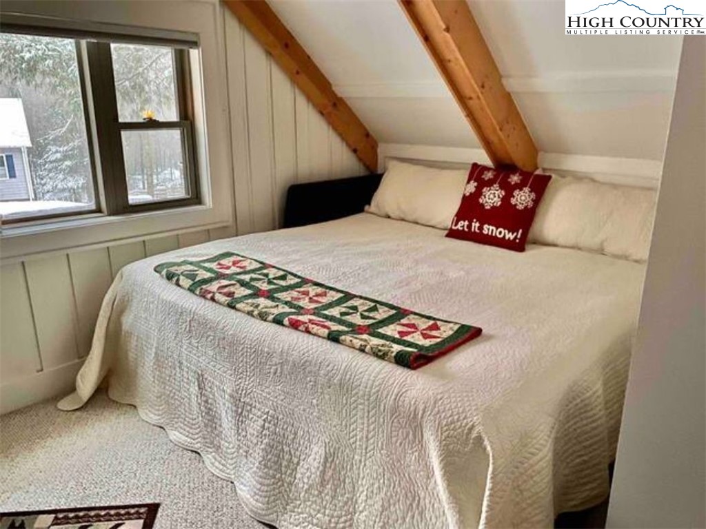 702 Pine Ridge Road Beech Mountain, NC 28604 - Photo 18 of 24 a bedroom with a bed and a window