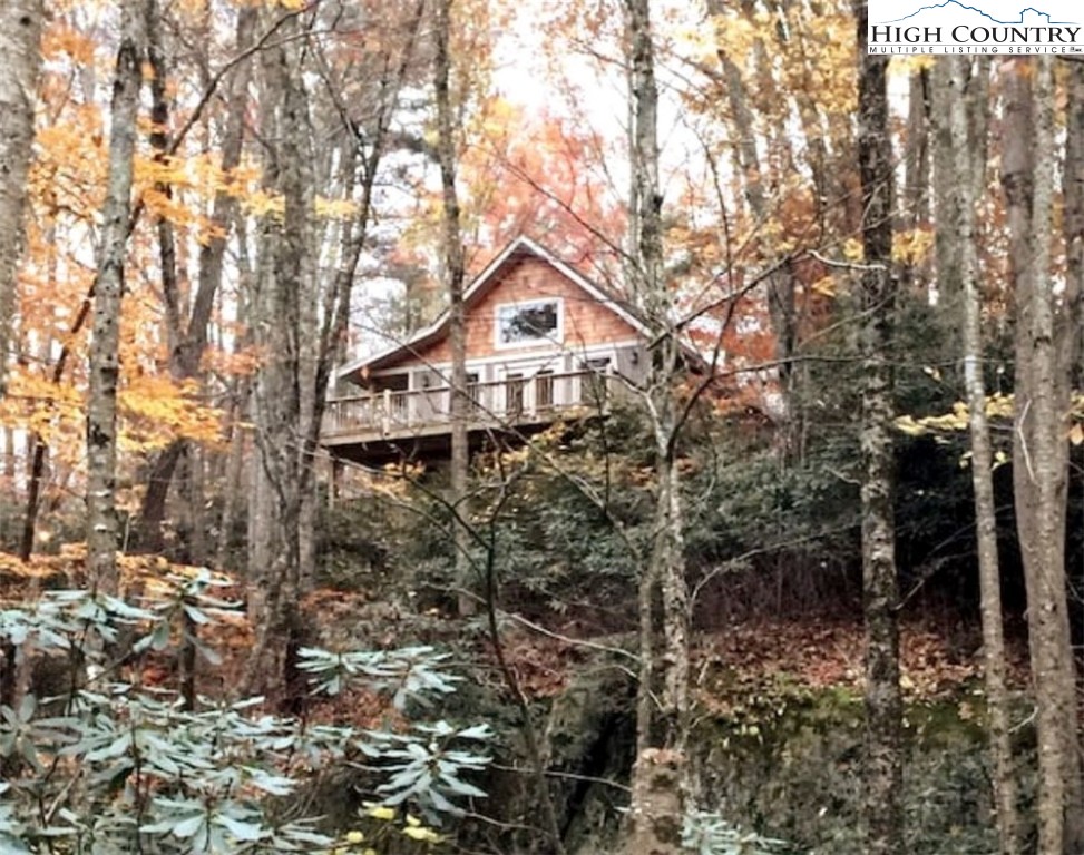 702 Pine Ridge Road Beech Mountain, NC 28604 - Photo 21 of 24 a house with a trees in front of it
