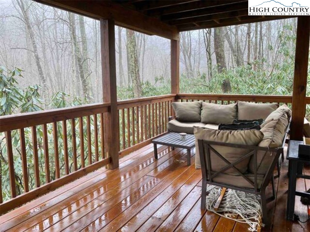 702 Pine Ridge Road Beech Mountain, NC 28604 - Photo 23 of 24 a balcony with wooden floor and outdoor seating