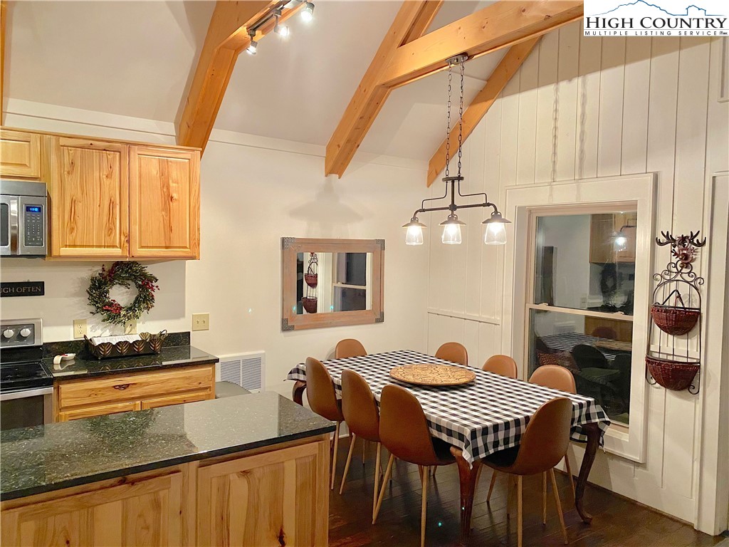 702 Pine Ridge Road Beech Mountain, NC 28604 - Photo 8 of 24 a view of a dining room with furniture and chandelier