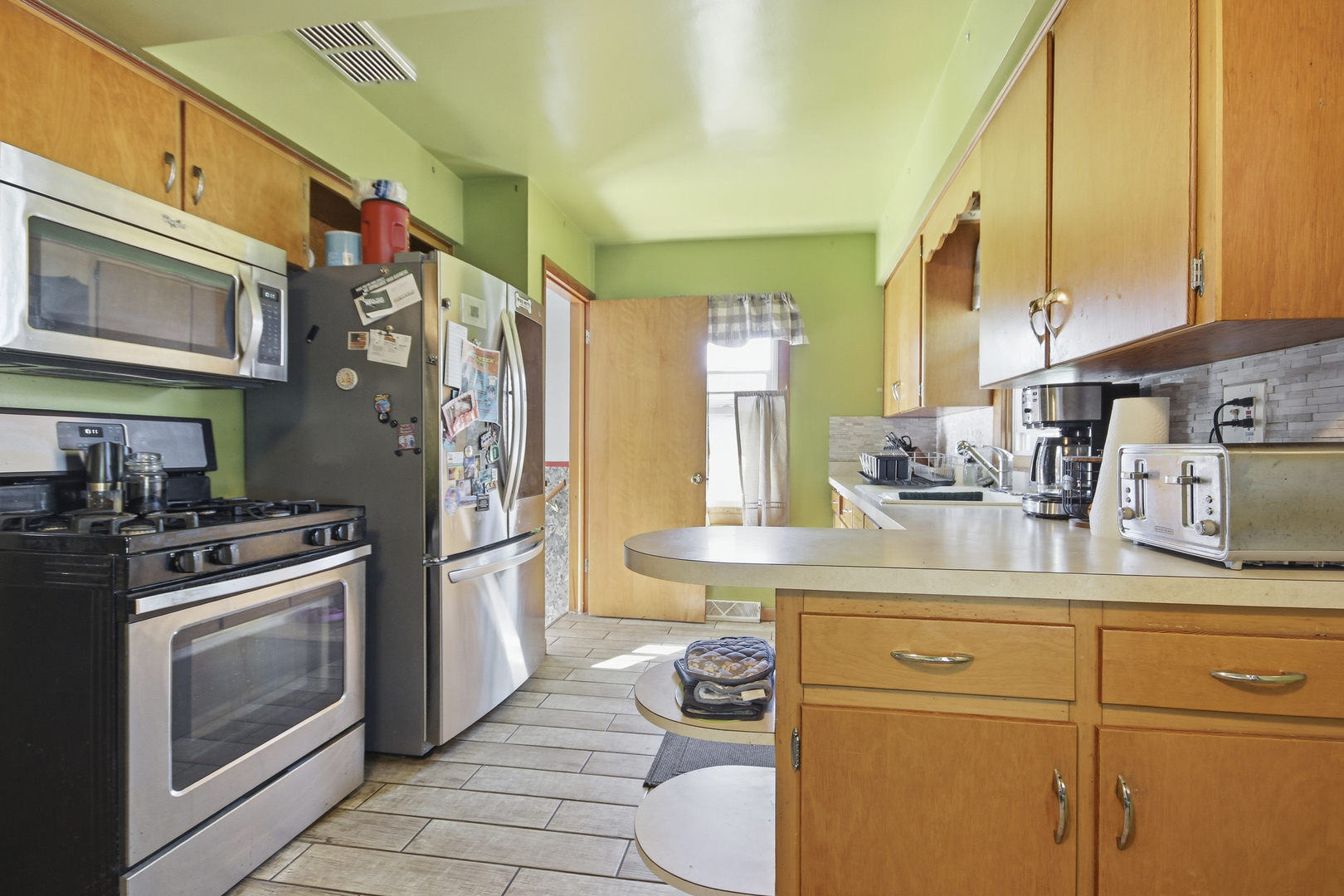 18655 Sherman Street Lansing, IL 60438 - Photo 8 of 21 a kitchen with stainless steel appliances granite countertop a stove and a sink