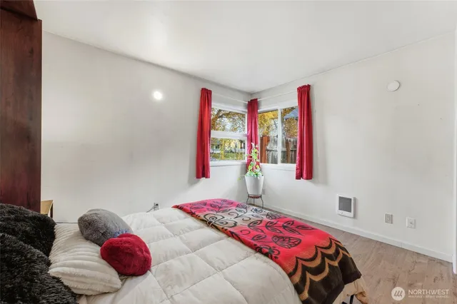 a bedroom with a bed and a window