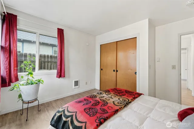 a bedroom with a bed and a potted plant