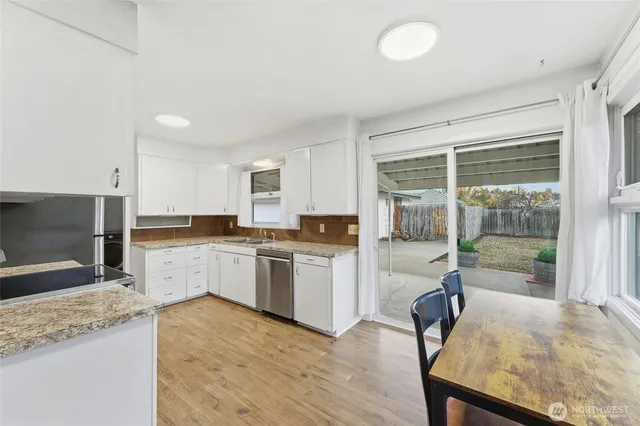 a kitchen with a stove a sink and a refrigerator