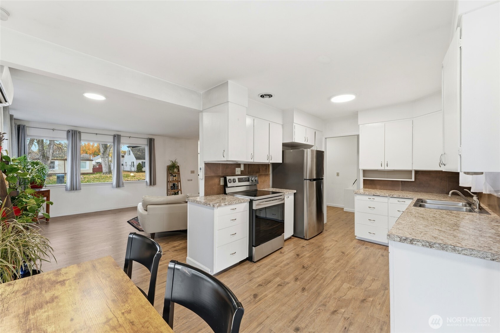624 Juniper Street Walla Walla, WA 99362 - Photo 7 of 25 a kitchen with a sink a stove a refrigerator cabinets and a dining table