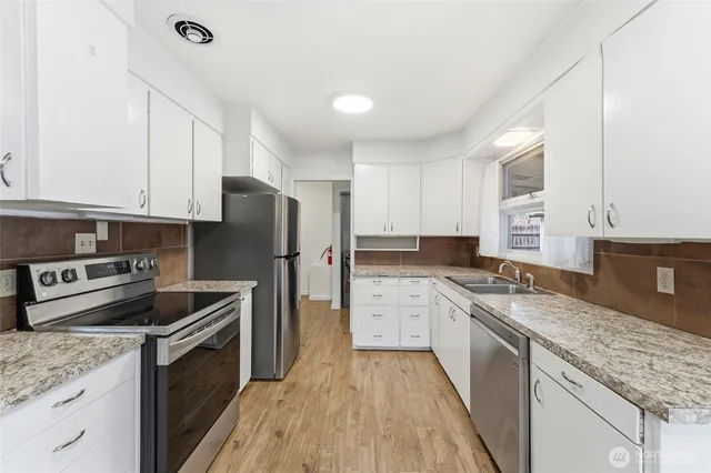 a kitchen with a stove sink and refrigerator