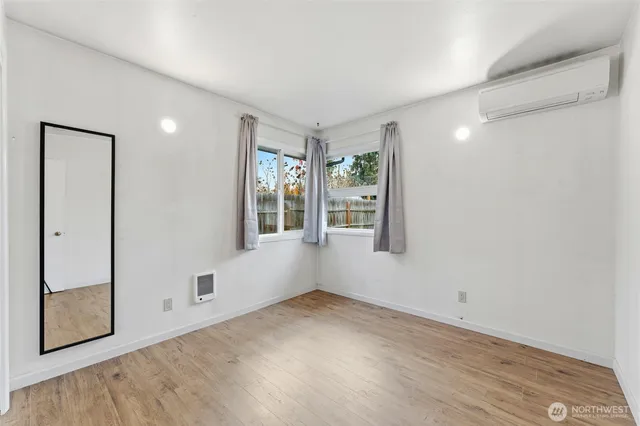 an empty room with windows and closet