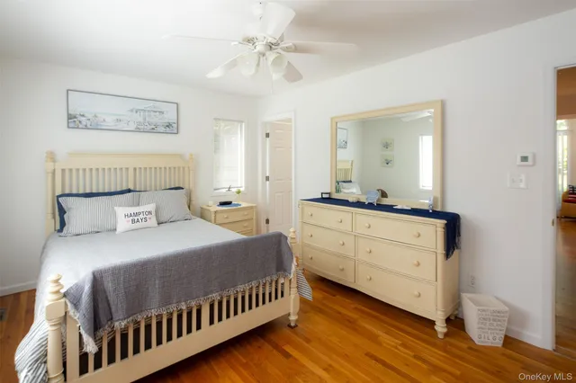 a bathroom with a toilet sink vanity and mirror