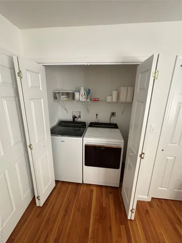 a bedroom with two beds and a chandelier