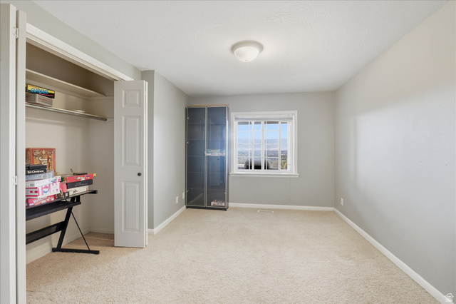 2887 View Crest Circle North Logan, UT 84341 - Photo 29 of 37 Unfurnished bedroom with light carpet and a closet