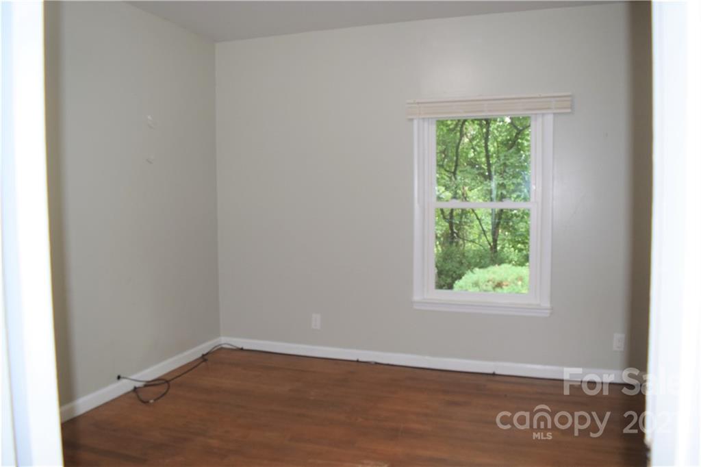 1533 Rosemount Road Sylva, NC 28779 - Photo 14 of 15 an empty room with wooden floor and windows