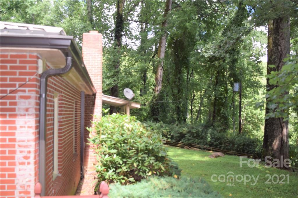 1533 Rosemount Road Sylva, NC 28779 - Photo 3 of 15 a backyard of a house with lots of green space and garden