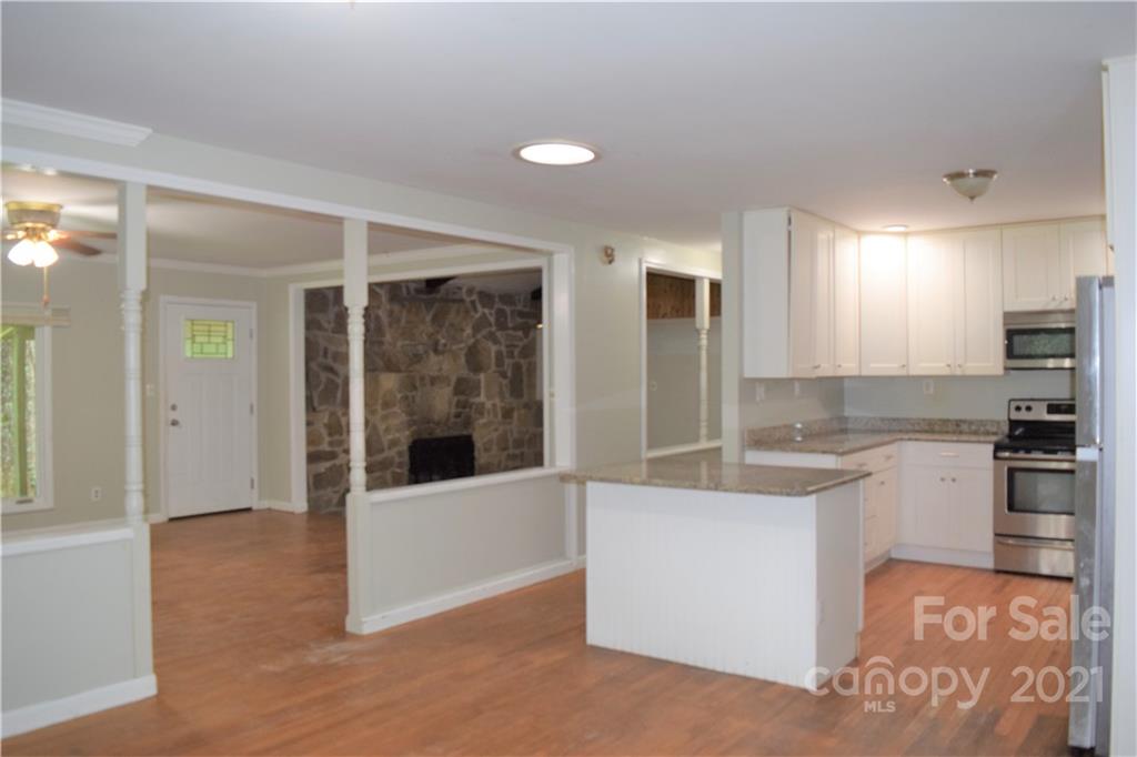 1533 Rosemount Road Sylva, NC 28779 - Photo 10 of 15 a large white kitchen with a sink and refrigerator