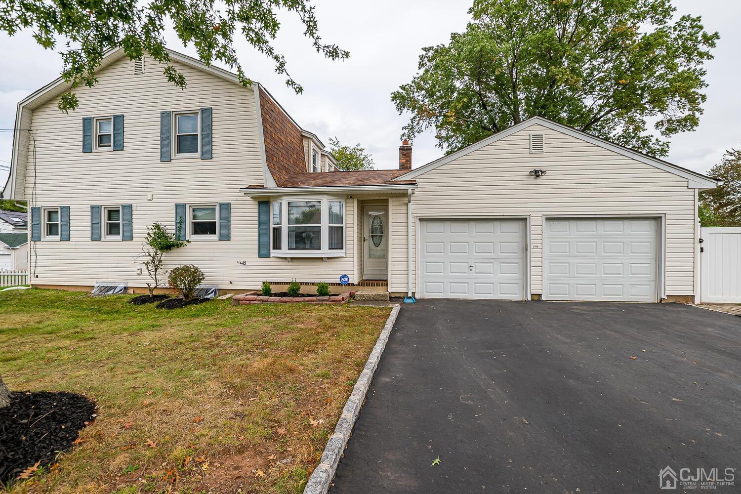 937 New Dover Road Edison, NJ 08820 - Photo 1 of 51 a front view of a house with garden