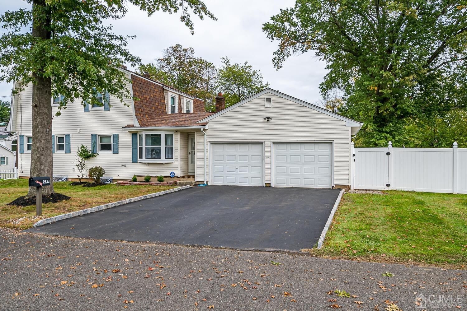 937 New Dover Road Edison, NJ 08820 - Photo 2 of 51 a front view of a house with a yard and garage