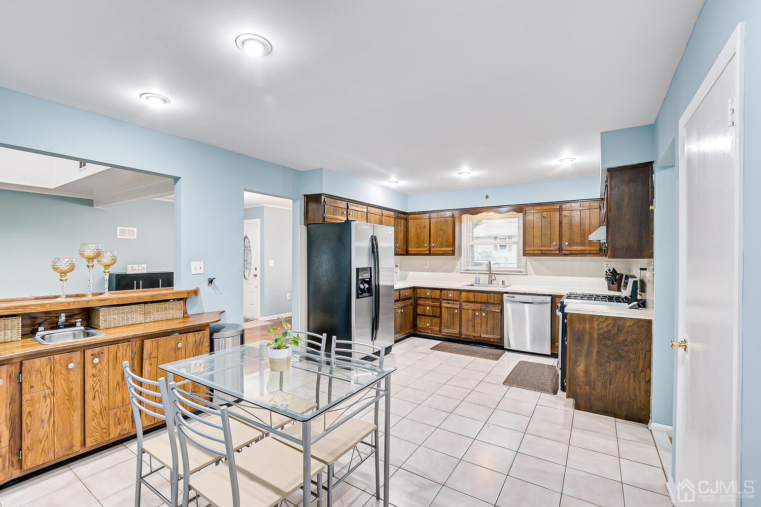 937 New Dover Road Edison, NJ 08820 - Photo 14 of 51 a kitchen with stainless steel appliances kitchen island granite countertop a stove a sink a refrigerator and cabinets