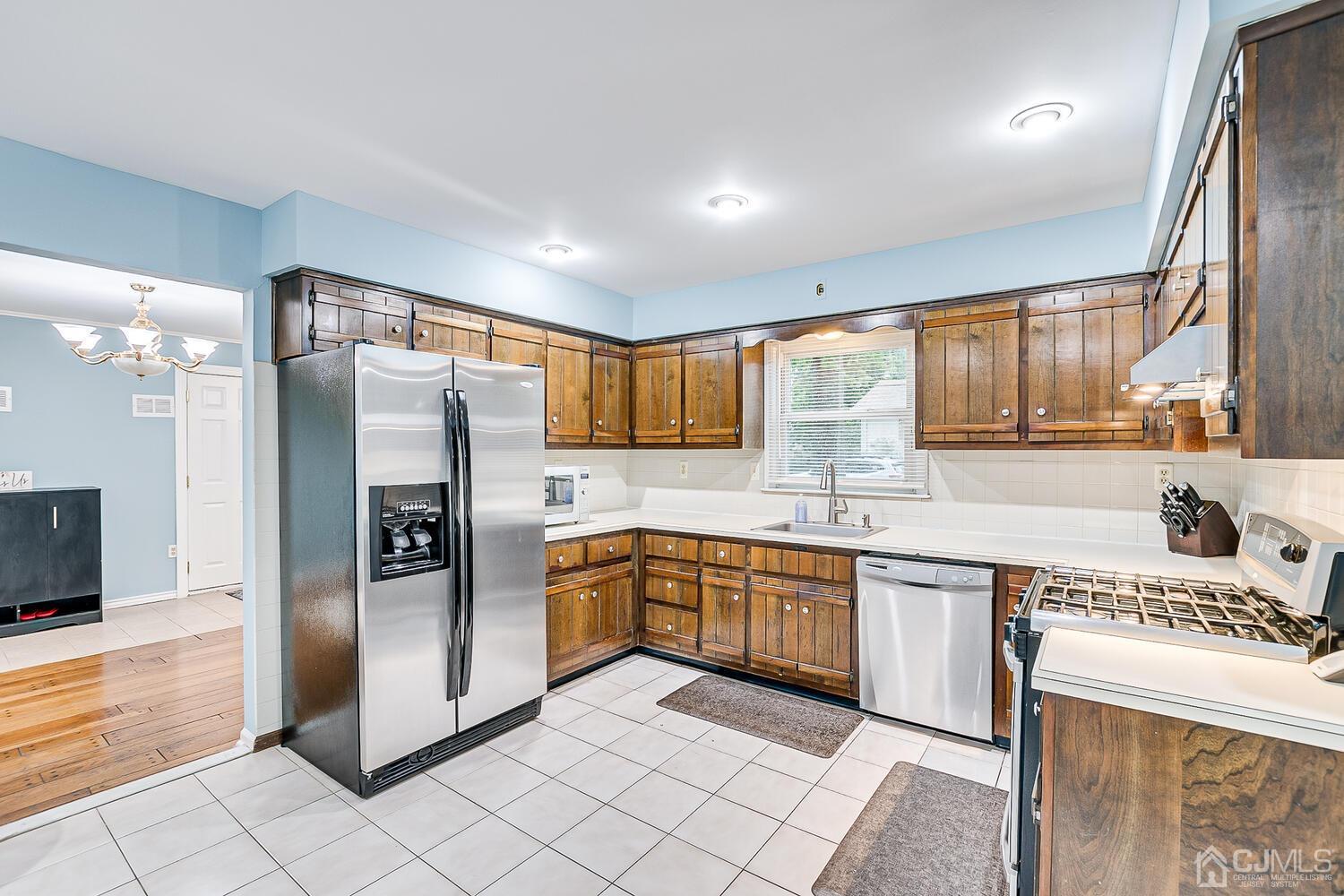 937 New Dover Road Edison, NJ 08820 - Photo 17 of 51 a kitchen with stainless steel appliances granite countertop a refrigerator and a sink