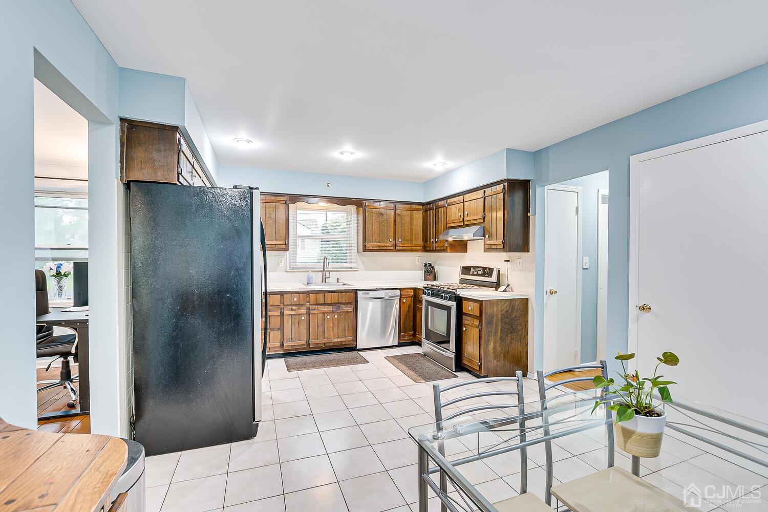 937 New Dover Road Edison, NJ 08820 - Photo 18 of 51 a kitchen with stainless steel appliances kitchen island granite countertop a refrigerator and a sink