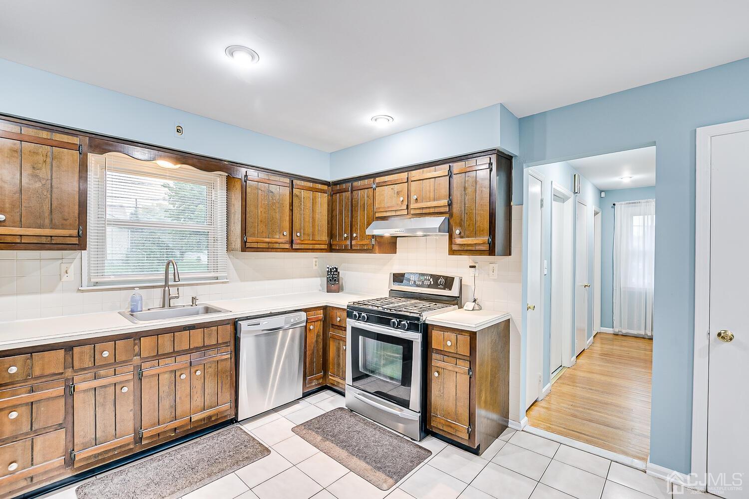 937 New Dover Road Edison, NJ 08820 - Photo 21 of 51 a kitchen with stainless steel appliances granite countertop a stove sink and cabinets