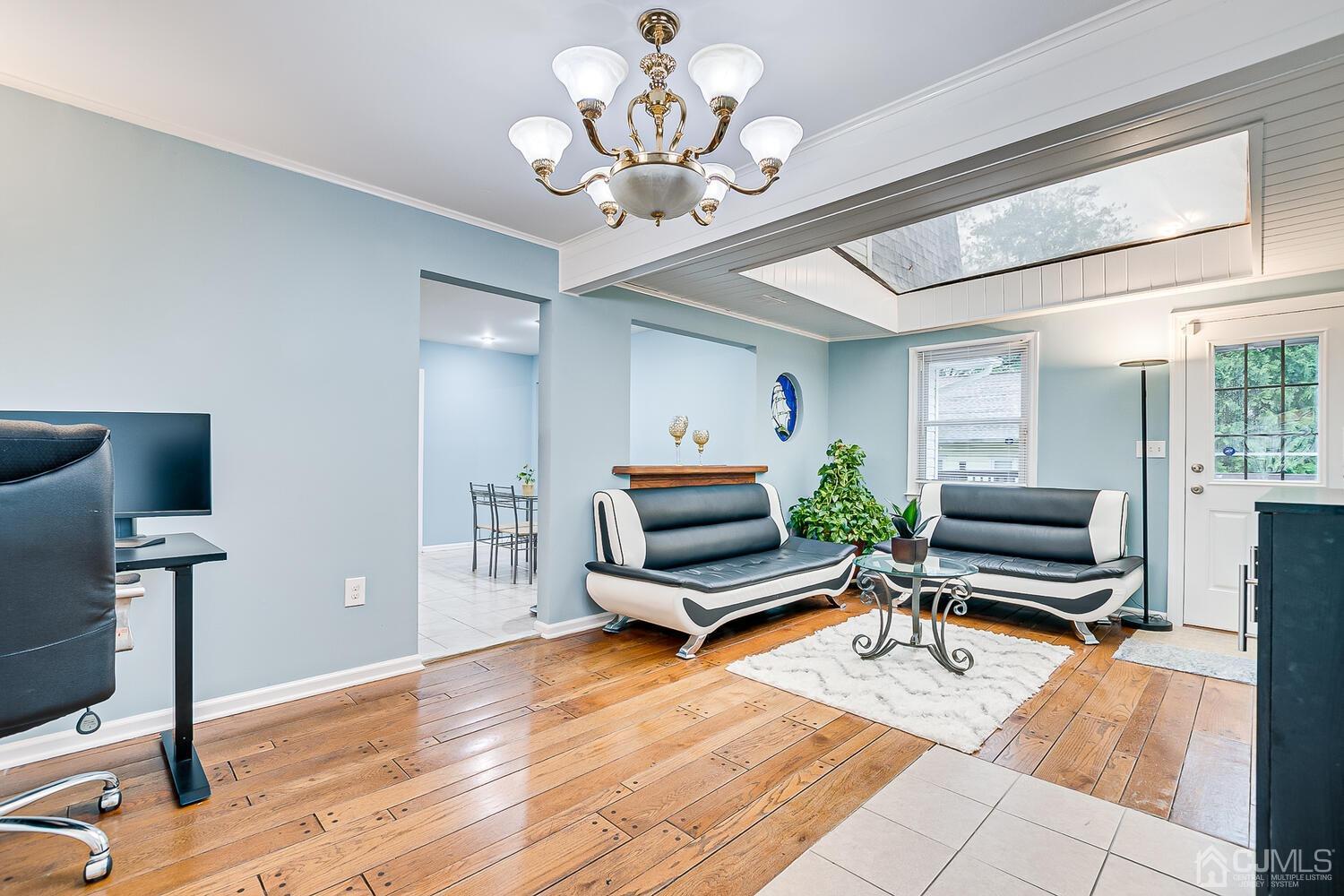 937 New Dover Road Edison, NJ 08820 - Photo 23 of 51 a living room with furniture a flat screen tv and a chandelier