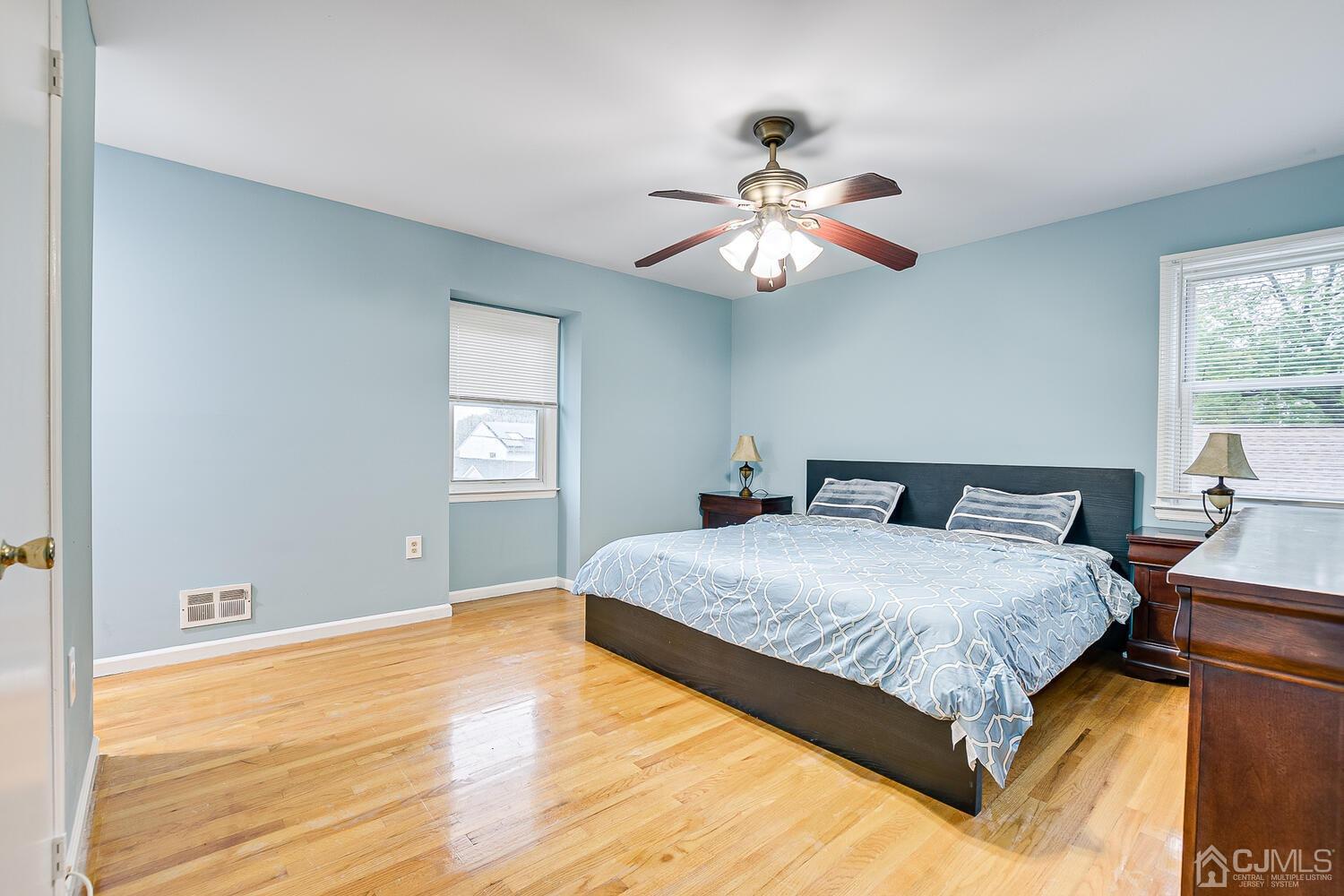 937 New Dover Road Edison, NJ 08820 - Photo 29 of 51 a bedroom with a large bed and a chandelier