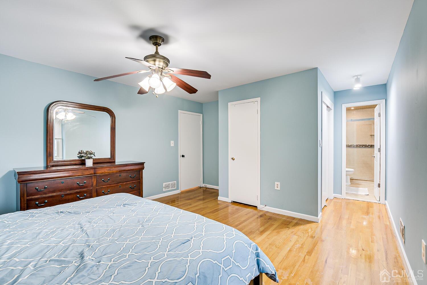937 New Dover Road Edison, NJ 08820 - Photo 30 of 51 a bedroom with a bed and a chandelier