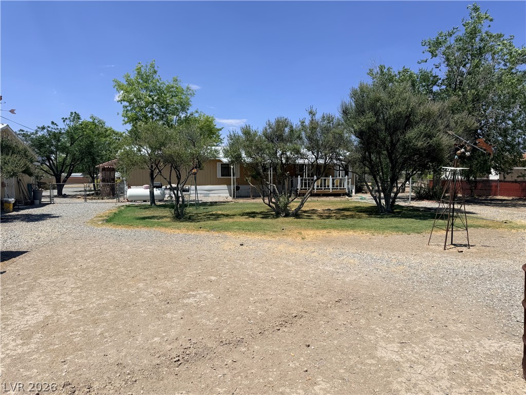 1391 West Dyer Road Pahrump, NV 89048 - Photo 23 of 50 A spacious gravel lot provides ample parking, with a charming porch adding curb appeal to this ranch-style residence.