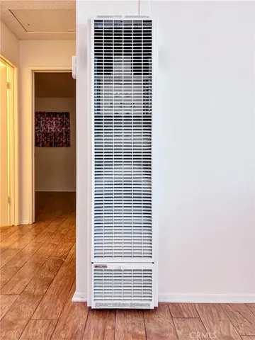 a view of a living room with furniture and wooden floor