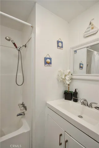 a bathroom with a sink a toilet and shower curtain