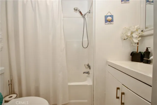 a view of a room with wooden floor and white walls