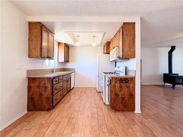 a stove top oven sitting inside of a kitchen