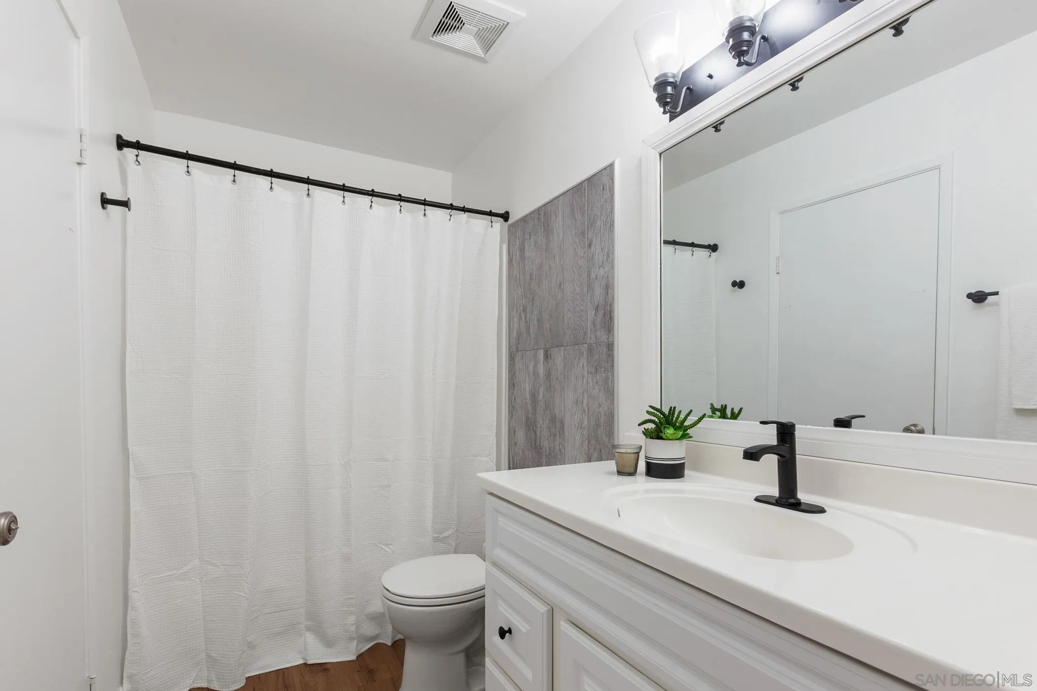 14283 Mariana Drive Poway, CA 92064 - Photo 16 of 28 a bathroom with a sink a toilet and a mirror