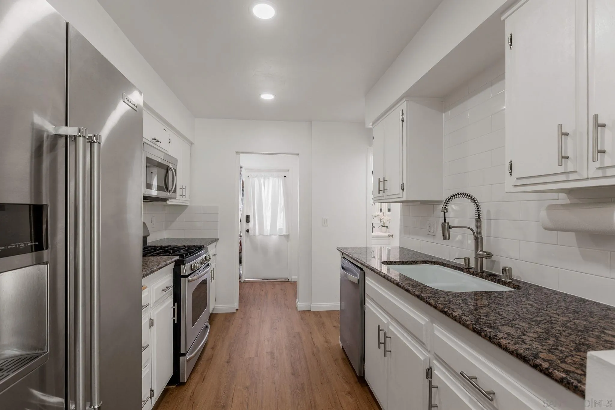 14283 Mariana Drive Poway, CA 92064 - Photo 7 of 28 a kitchen with granite countertop a sink stainless steel appliances and cabinets