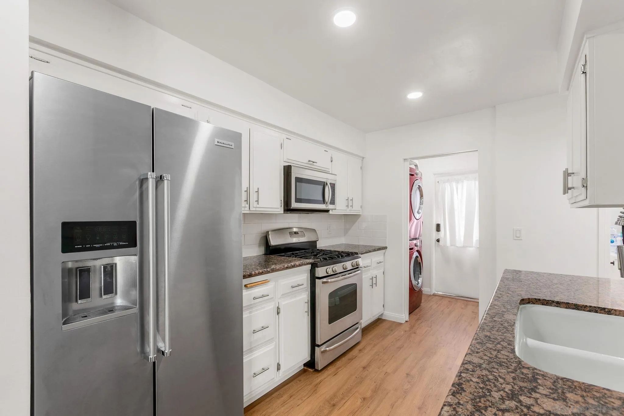 14283 Mariana Drive Poway, CA 92064 - Photo 8 of 28 a kitchen with stainless steel appliances granite countertop a refrigerator a stove and a sink